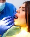 Woman Receiving Dental Exam Dentist